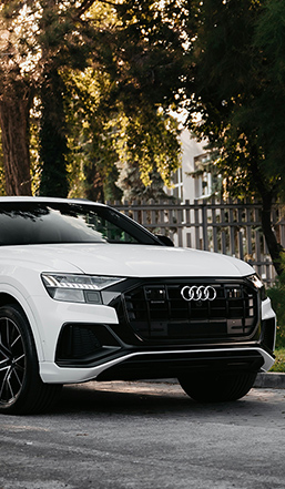 A red Audi RS7 sports sedan parked on the side of a road